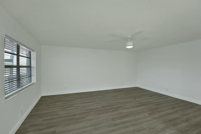 spare room with dark hardwood / wood-style floors and ceiling fan