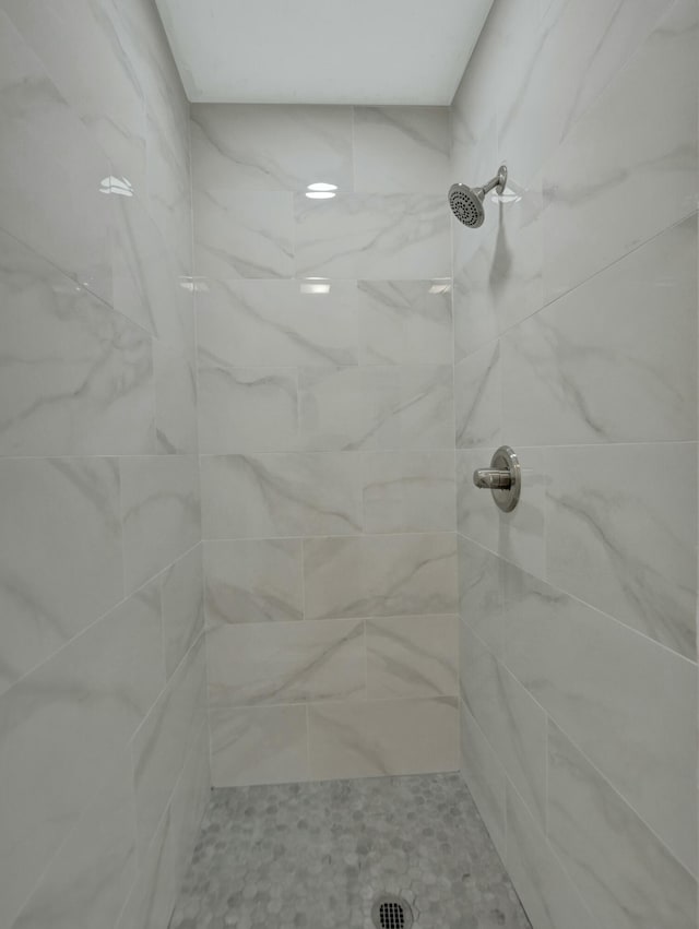 bathroom with tiled shower