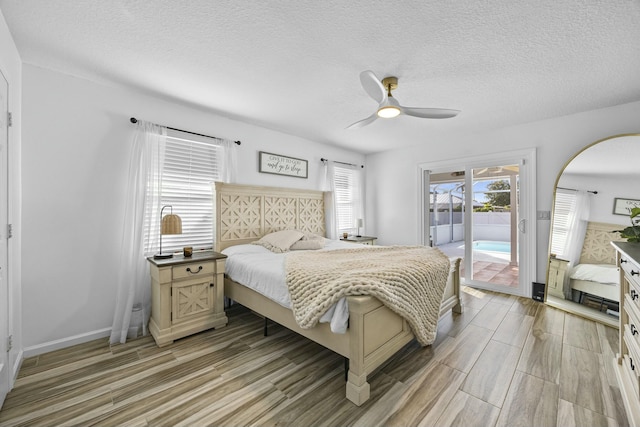 bedroom featuring access to exterior, a textured ceiling, light wood-type flooring, and ceiling fan