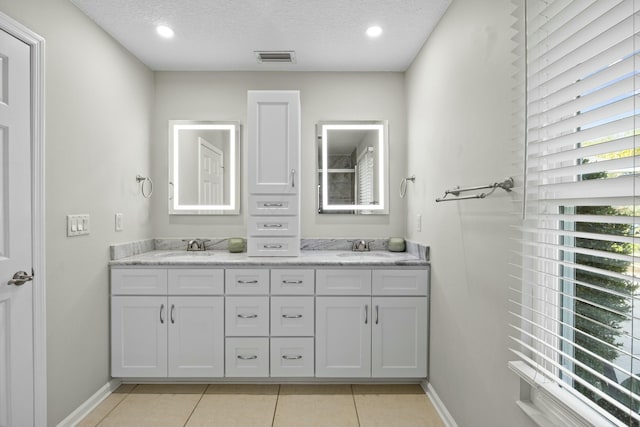 bathroom featuring vanity, a textured ceiling, and tile patterned floors