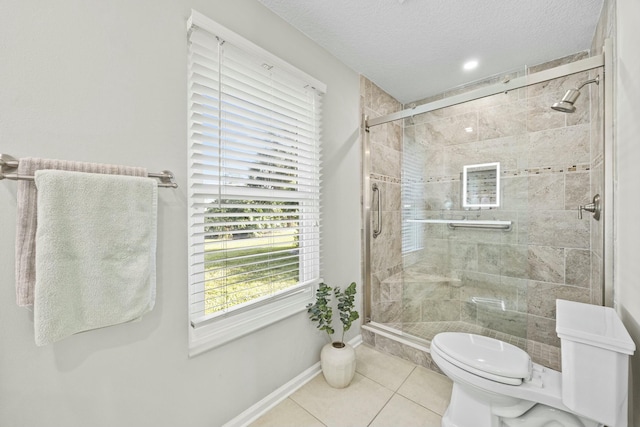 bathroom featuring toilet, a textured ceiling, tile patterned floors, and a shower with shower door