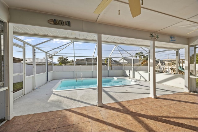 view of swimming pool with a patio and glass enclosure