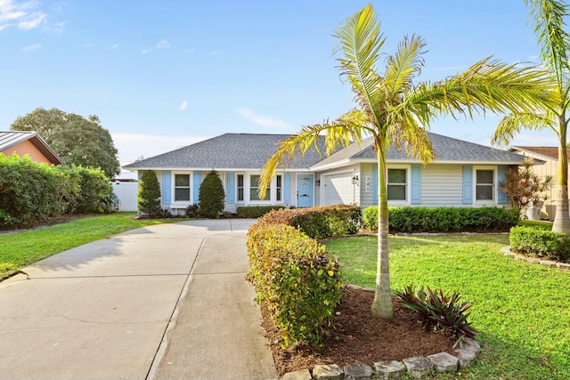 single story home featuring a garage and a front yard