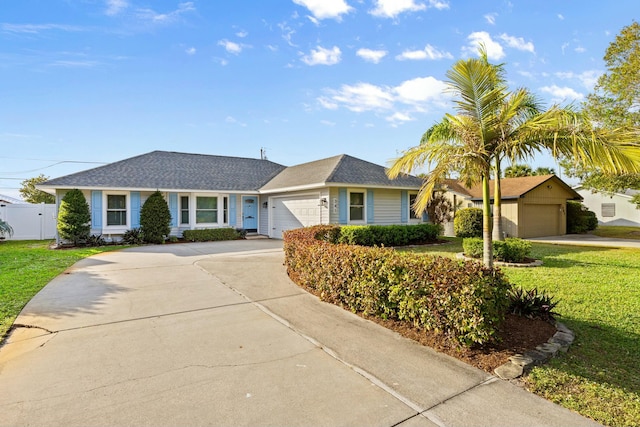 ranch-style house featuring a garage and a front yard