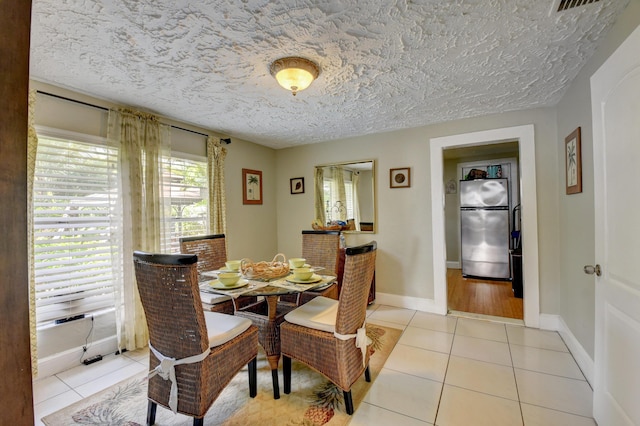 dining space with light tile patterned floors