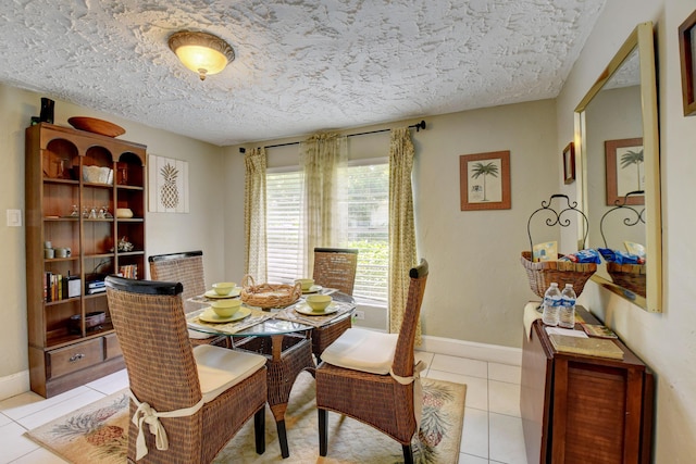 tiled dining area with a textured ceiling