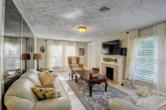 tiled living room with a healthy amount of sunlight and a tiled fireplace