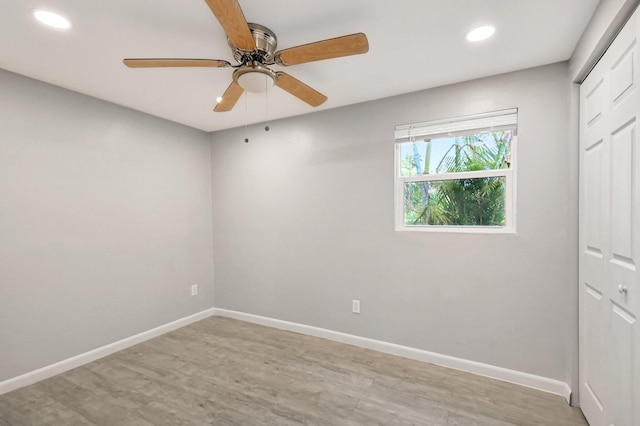 unfurnished room with ceiling fan and light wood-type flooring