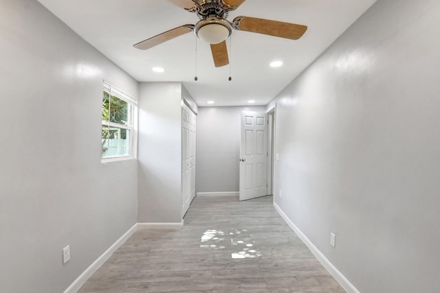 corridor with light hardwood / wood-style flooring