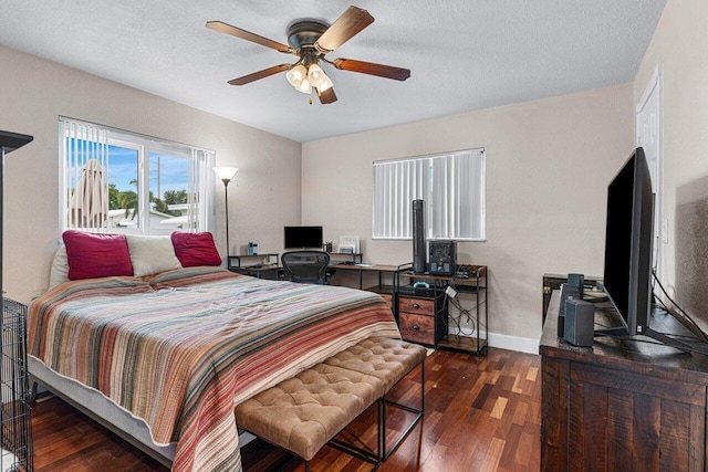 bedroom with dark hardwood / wood-style flooring, a textured ceiling, and ceiling fan