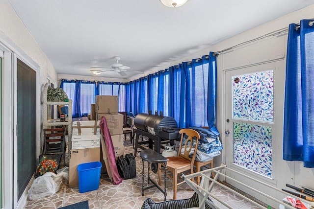 interior space with ceiling fan