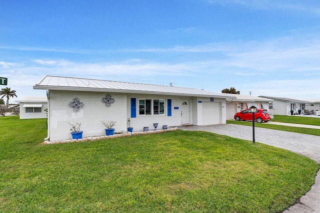 ranch-style home with a garage and a front yard