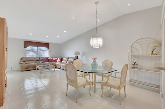 tiled dining room featuring a notable chandelier and lofted ceiling