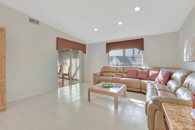 living room with light tile patterned floors and vaulted ceiling