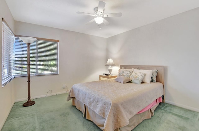 bedroom featuring ceiling fan and carpet