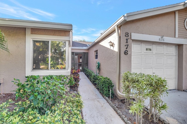 view of exterior entry with a garage