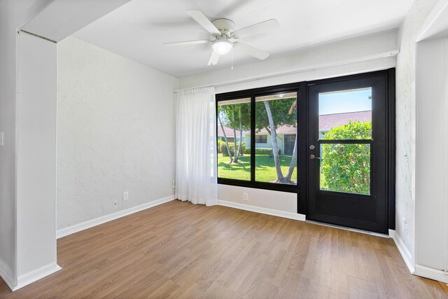 dining room with ceiling fan with notable chandelier and light wood-type flooring