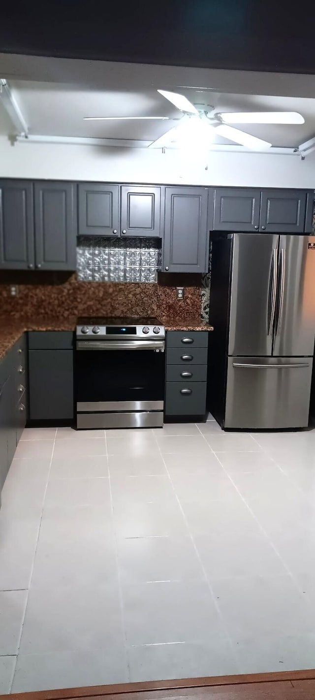 kitchen with light tile patterned floors, appliances with stainless steel finishes, and gray cabinetry