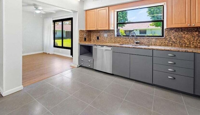 kitchen featuring dishwasher, light brown cabinetry, backsplash, gray cabinetry, and sink