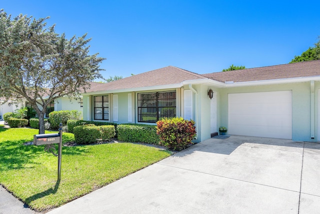 ranch-style home with stucco siding, an attached garage, concrete driveway, and a front lawn