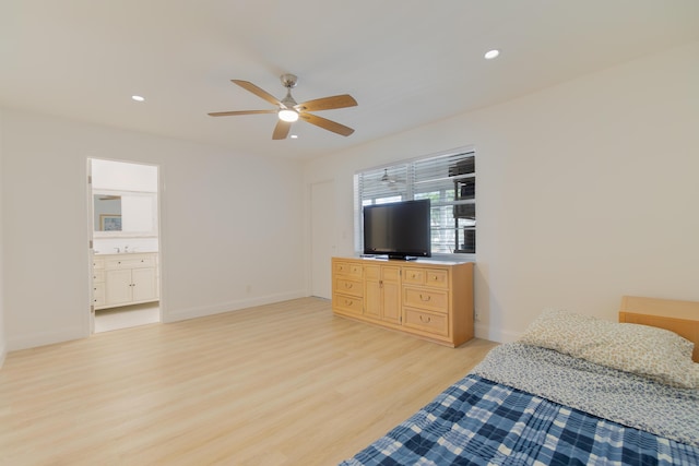 bedroom featuring ceiling fan, ensuite bath, sink, and light hardwood / wood-style flooring