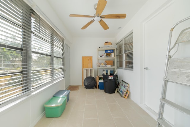 miscellaneous room with ceiling fan, a wealth of natural light, and light tile patterned floors