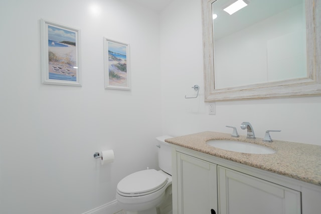 bathroom featuring toilet and vanity