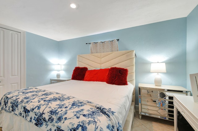 tiled bedroom with a closet