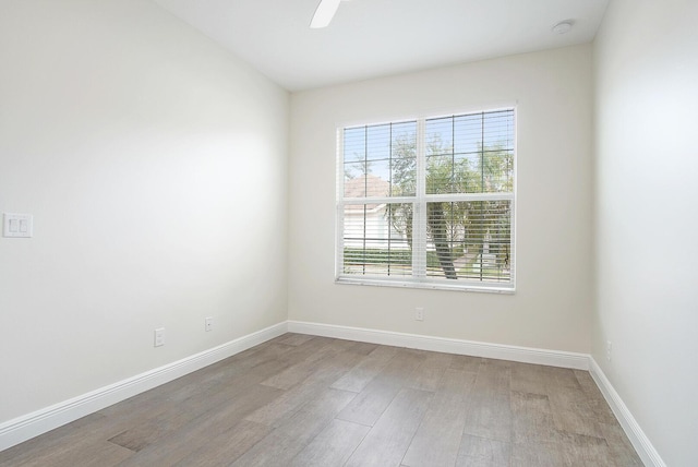 unfurnished room featuring ceiling fan and light wood-type flooring