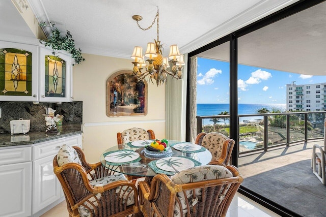 dining area featuring light tile patterned floors, a water view, and a wealth of natural light