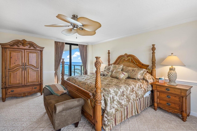 carpeted bedroom featuring access to outside, ceiling fan, crown molding, and a water view