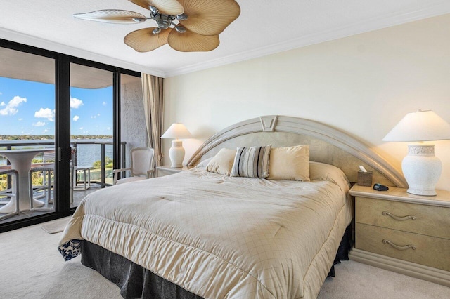 bedroom featuring access to outside, expansive windows, crown molding, ceiling fan, and light colored carpet