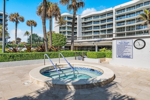 view of swimming pool featuring a community hot tub