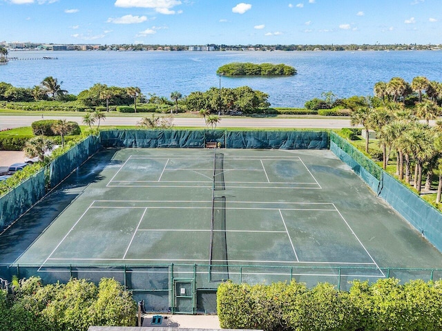 view of tennis court featuring a water view