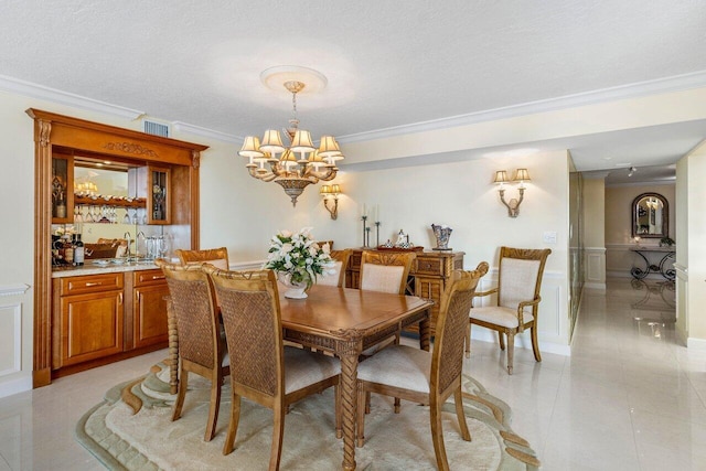 dining room featuring ornamental molding, a textured ceiling, and a chandelier