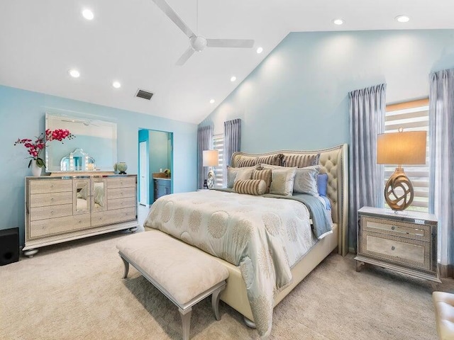 carpeted bedroom with ceiling fan and high vaulted ceiling