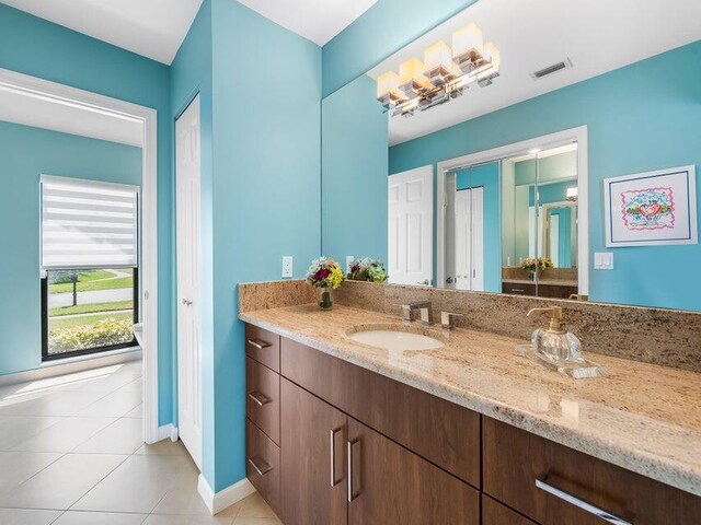 bathroom featuring tile patterned flooring and vanity