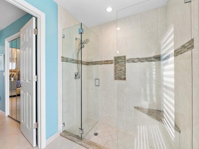 bathroom featuring tile patterned floors and an enclosed shower