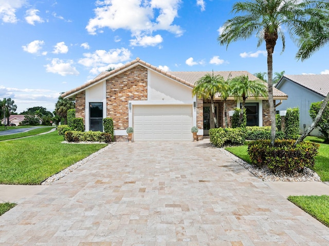 view of front of house featuring a garage and a front lawn