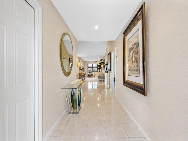 hall featuring light tile patterned floors