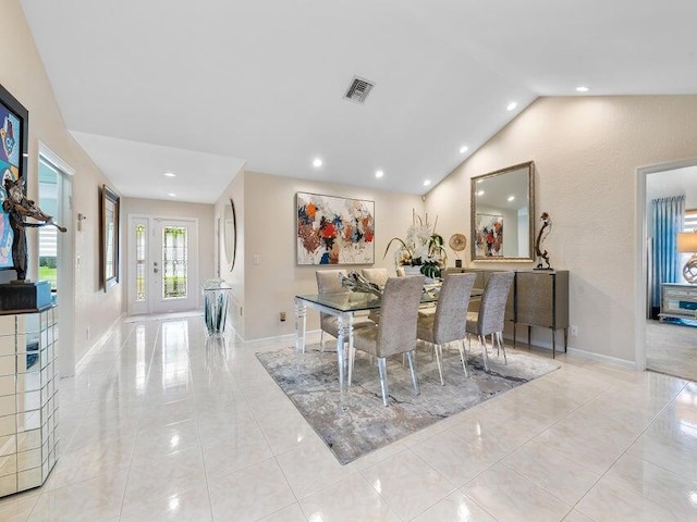 dining space featuring light tile patterned floors and lofted ceiling