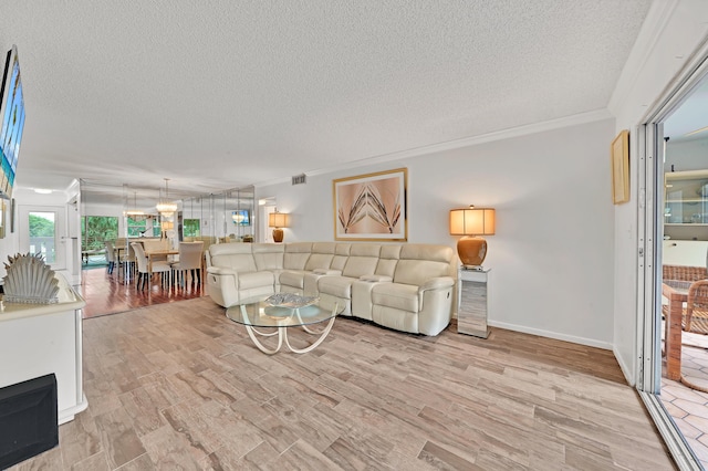 living room with a textured ceiling, light hardwood / wood-style floors, and ornamental molding