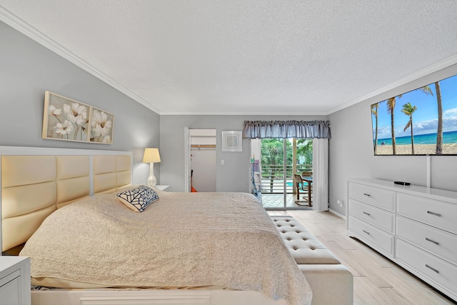 bedroom with access to exterior, a textured ceiling, light hardwood / wood-style floors, and ornamental molding