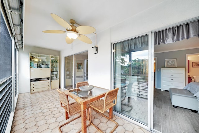 dining area with ceiling fan and ornamental molding