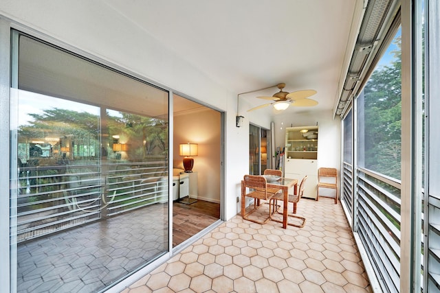 sunroom / solarium featuring a wealth of natural light and ceiling fan