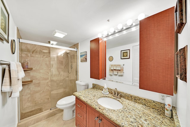 bathroom with tile patterned floors, vanity, toilet, and walk in shower