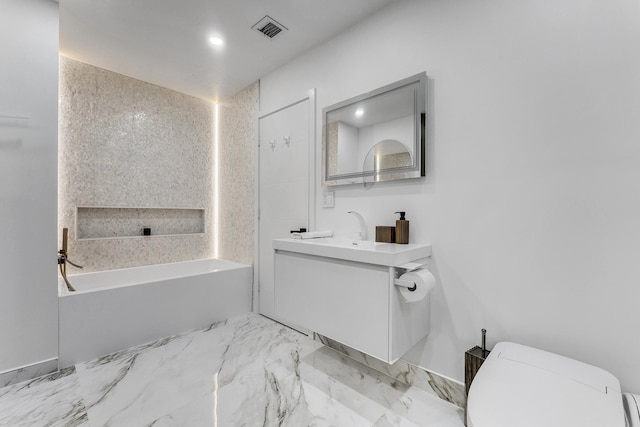 bathroom with a bathtub, vanity, and toilet