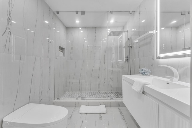 bathroom with tile walls, vanity, an enclosed shower, and toilet