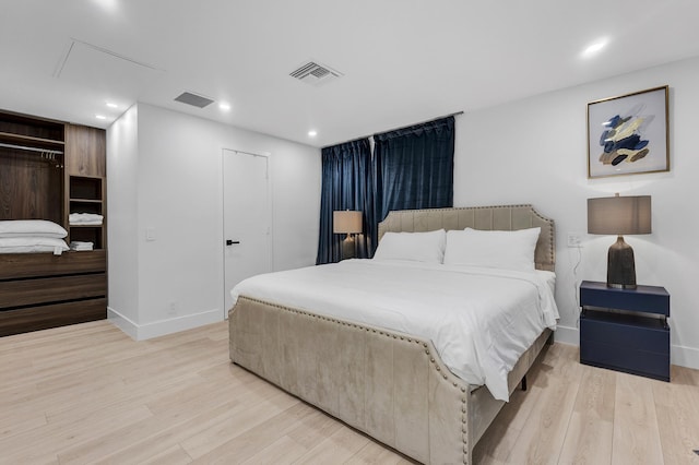 bedroom featuring a closet and light wood-type flooring