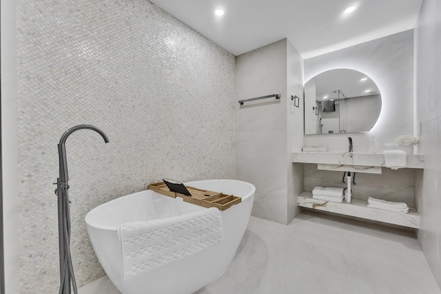 bathroom featuring a bathtub and tile walls